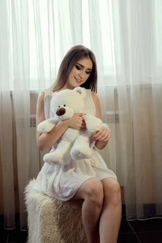 Girl with teddy bear for lifestyle design. Young caucasian model. Beautiful woman face. Beautiful smiling young woman. Beautiful woman face. Caucasian young woman. Beautiful hair.