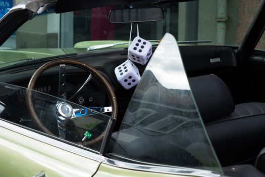 Fuzzy Dice on the rearview mirror of a vintage American car