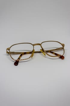 old glasses closeup with white background as product photo. with gold frames.