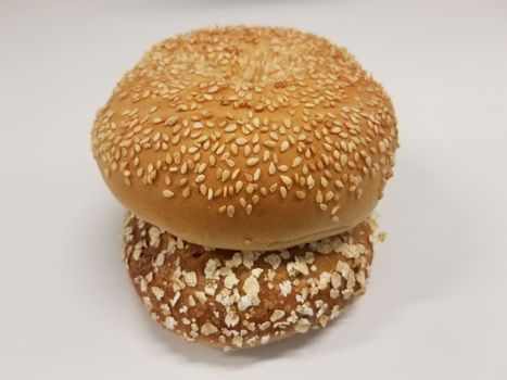oat and seed bagels in stack on white surface or table