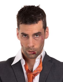 Close up of a businessman with bloody lip, beaten and bruised, isolated