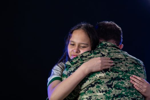 Soldier hugs daughter on departing or returning from war