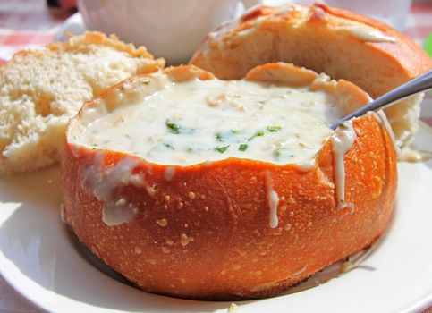 The most famous and popular in San Francisco mussel soup in a pot of bread