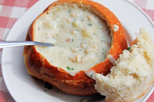 The most famous and popular in San Francisco mussel soup in a pot of bread