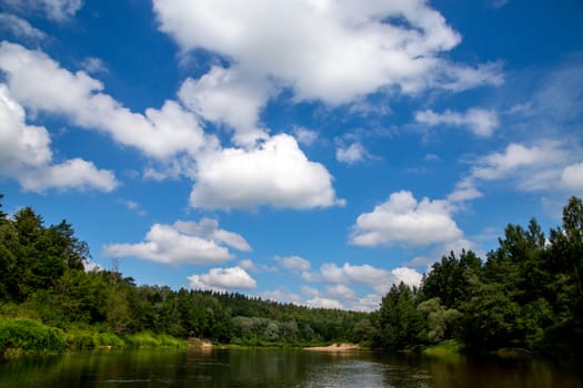 Summer landscape with river, forest and cloudy blue sky. The Gauja is the longest river in Latvia, which is located only in the territory of Latvia. 


