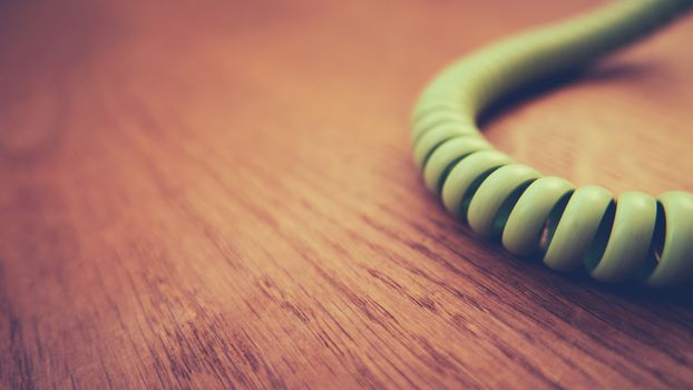 Retro Vintage Phone Cord On Wooden Floorboards With Shallow Focus And Copy Space