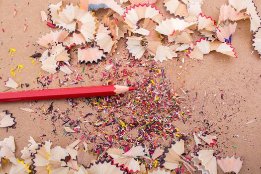 Red Color Pencil over some  pencil shavings