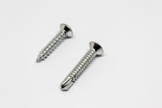 isolated two metal screw with white background.can be used as product photo.
