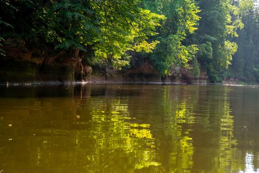 Landscape with cliff near the river Gauja and forest in the background. The Gauja is the longest river in Latvia, which is located only in the territory of Latvia. 

