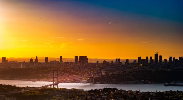 Cityscape of Istanbul with Bosphorus, skyscrapers, and 15th July Martyrs Bridge Bosphorus Bridge from Camlica hill at sunset Istanbul, Turkey