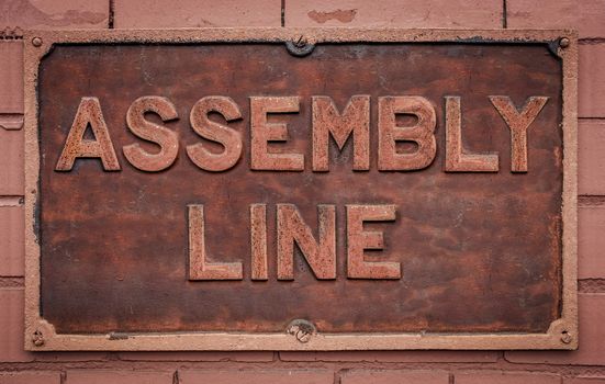 A Grungy Metal Sign For A Manufacturing Assembly Line