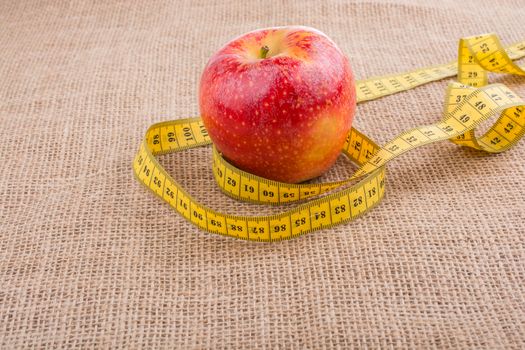 Health and diet concept with apple with a measurement  tape