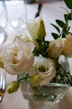 White pink and yellow roses flowers on table for a wedding