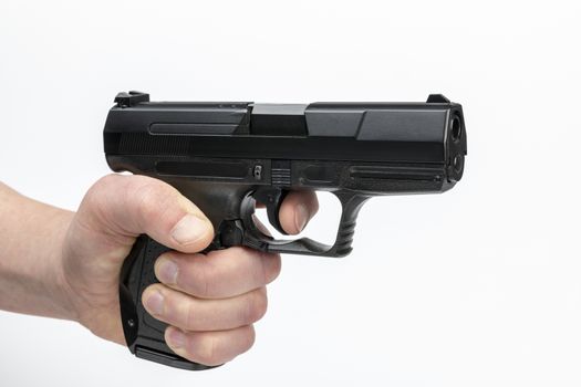 Hand of a male with firearm being a black pistol
