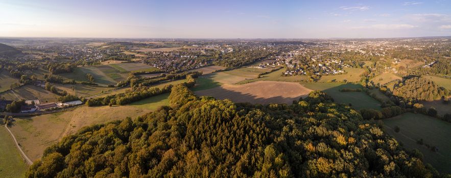 Aerial panorama of meadows and forrests next to the West German city Aachen in the Eifel region