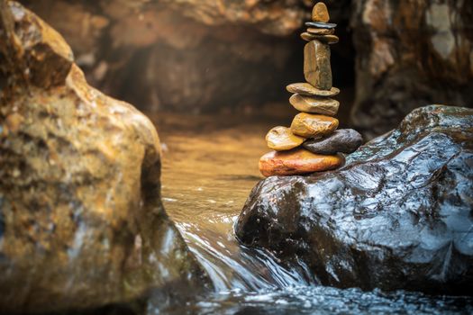 Stone balance stacking at riverside and morning sunlight. Concepts of Concepts of Zen religion or meditation practice.