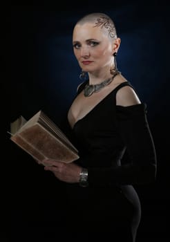 Portrait of a bald woman with a book