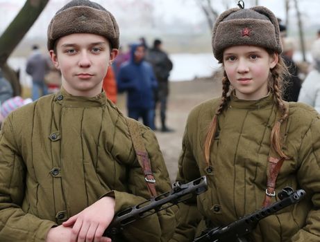boy and girl in clothes guerrillas vkrasnoy Army WWII.Children of the Second World War