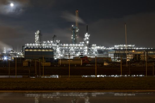 Night view of an industrial zone with the rail road transporting in and out raw material