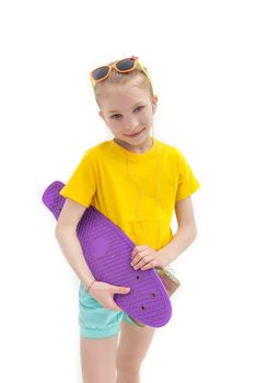 Girl standing with violete skateboard isolated on white in studio