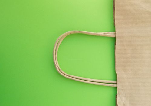 Concept of zero waste, reusable paper bag for shopping, free plastic, green background, top view.