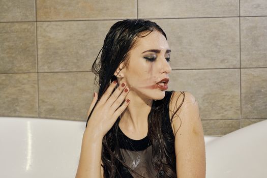 Young woman portrait with dripping smeared makeup dressed in the black bathing suit posing in the bathroom. Conceptual fashion photography for design. Young woman for lifestyle design.