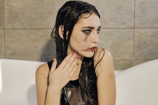 Young woman portrait with dripping smeared makeup dressed in the black bathing suit posing in the bathroom. Conceptual fashion photography for design. Young woman for lifestyle design.