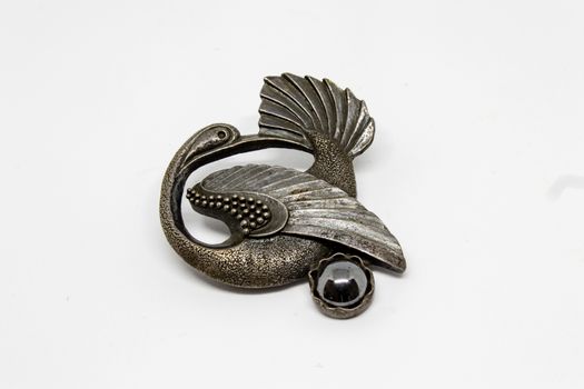 a good looking antique silver swan shaped badge with white background