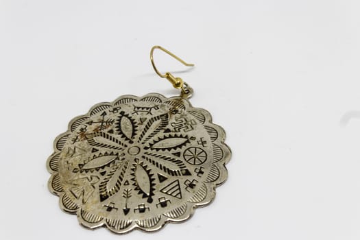 a good looking old silver badge with flower pattern. product whoot with white background.