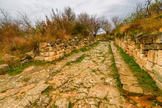 Road in the empty autumn cave city of Chufut-Kale, landmark of the Crimea, Russia