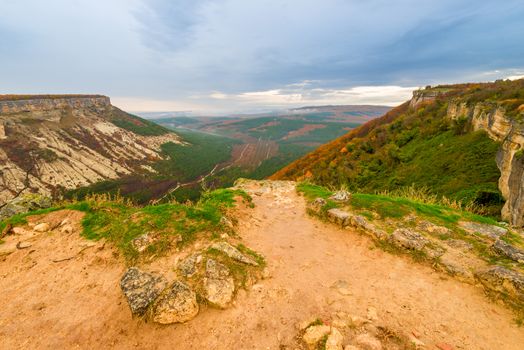 Autumn mountain landscape - a view of the valley on a cloudy day and a table mountain