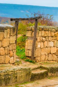 view of the stone wall of Chufut-Kale, a cave city in the Crimea