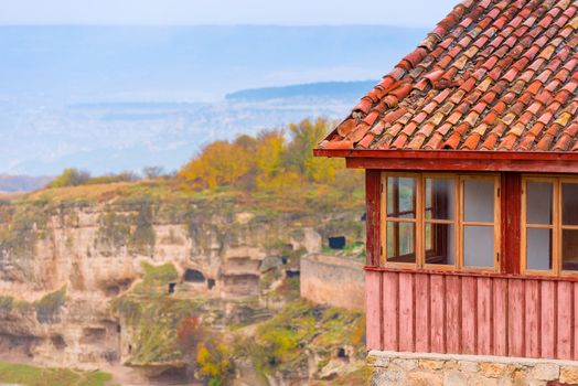 Fragment of the house, view of the cave city in the Crimea on a cloudy autumn day