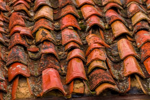 close-up clay old shingles on the roof of an old house