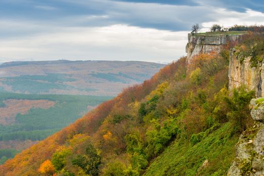 Mountain slope, cloudy day in the valley, autumn landscape