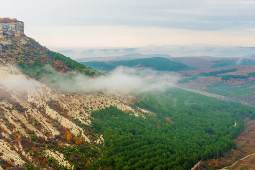 View from the mountain to the valley, shooting on a cloudy autumn day