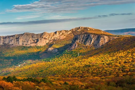 Beautiful rocky mountains and a view of the autumn forest at the foot, beautiful scenery