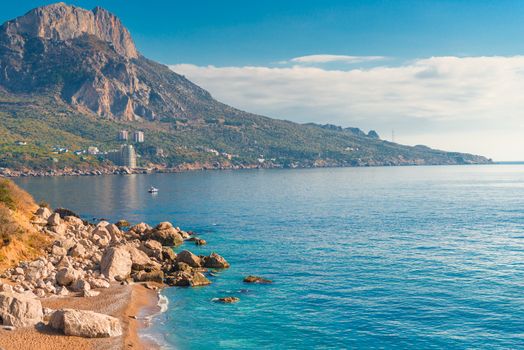 High mountains, rocks and blue calm sea on a sunny day