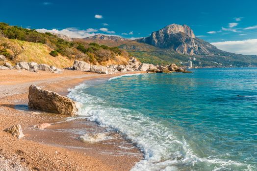 a sea wave on a sandy beach, a seascape in the autumn afternoon