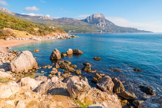 Picturesque empty beach of a bay surrounded by mountains