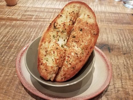 slices of seasoned garlic bread in a bowl on a table