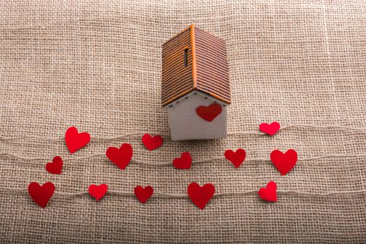 Heart shaped icons and paper house on linen threads