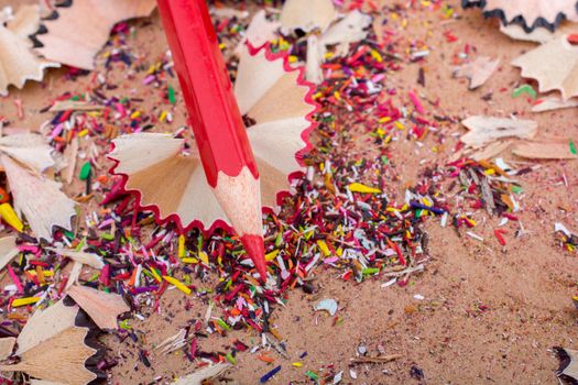 Red Color Pencil over some  pencil shavings