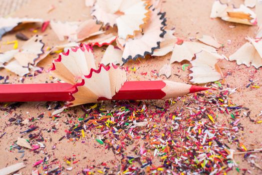 Red Color Pencil over some  pencil shavings