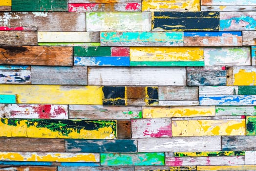 Close-up shot of colorfully painted wood wall texture