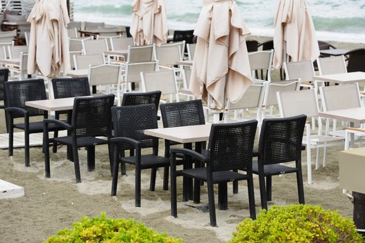 Empty beach outdoor cafe at low season with bad weather with no people. Leptokaria, Makedonia, Greece