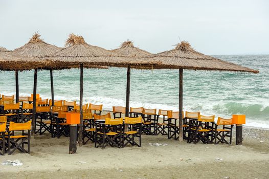 Empty beach outdoor cafe at low season with bad weather with no people. Leptokaria, Makedonia, Greece