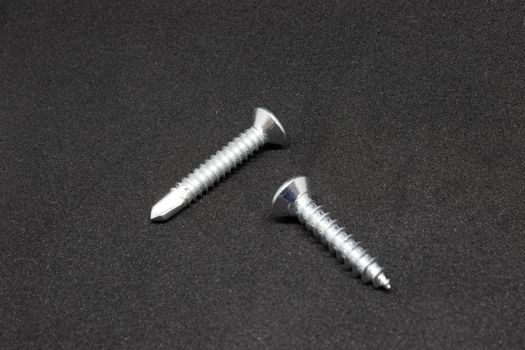 some isolated metal screw closeup shoot. photo has taken with photobox with black background.