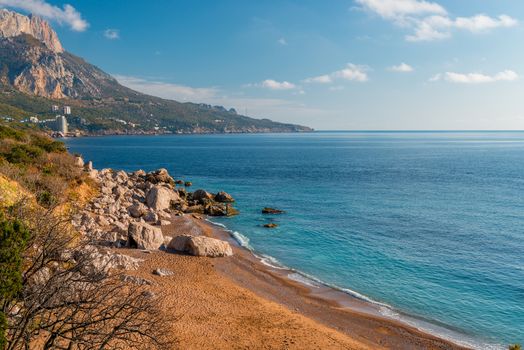 Stone boulders on an empty seashore, picturesque seascape