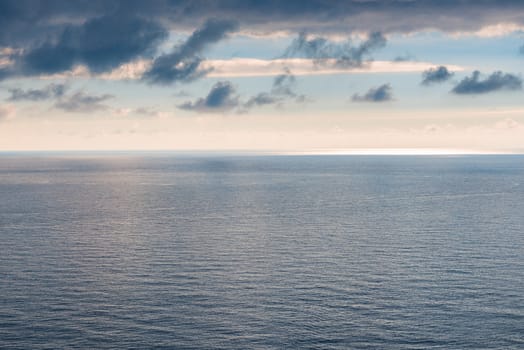 Water smooth surface of the sea, horizon and gloomy sky laconic landscape